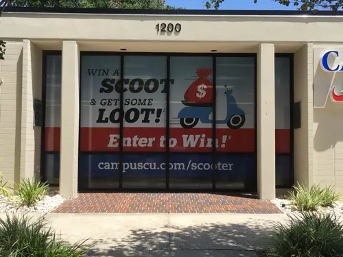Perforated one-way window graphic applied to storefront glass (example 11)