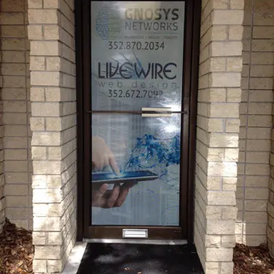 Perforated one-way window graphic applied to storefront glass (example 12)