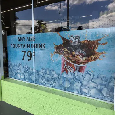 Perforated one-way window graphic applied to storefront glass (example 5)