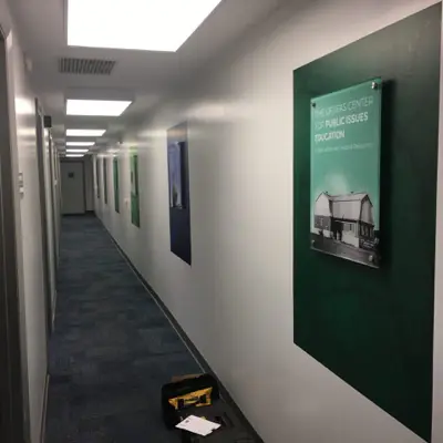 Acrylic lobby panel mounted on polished standoff hardware (example 12)