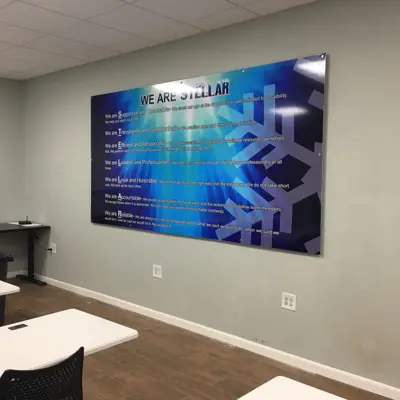Acrylic lobby panel mounted on polished standoff hardware (example 9)